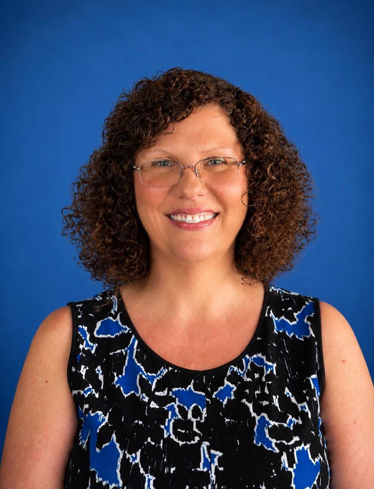 Photo of Tiffany Kell in front of a blue background