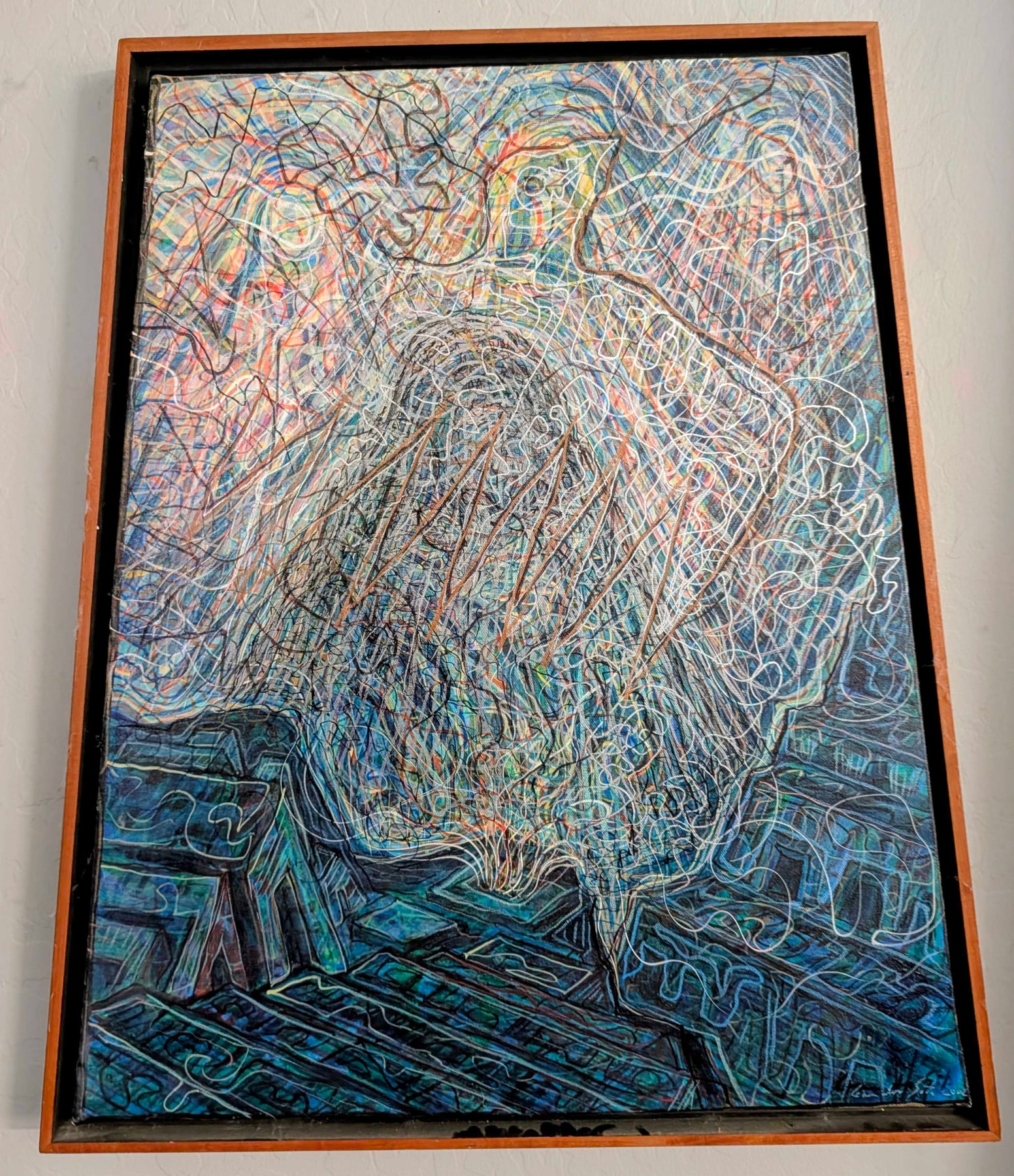 A framed artwork filled with overlapping blue, green, red and white lines and a central human figure