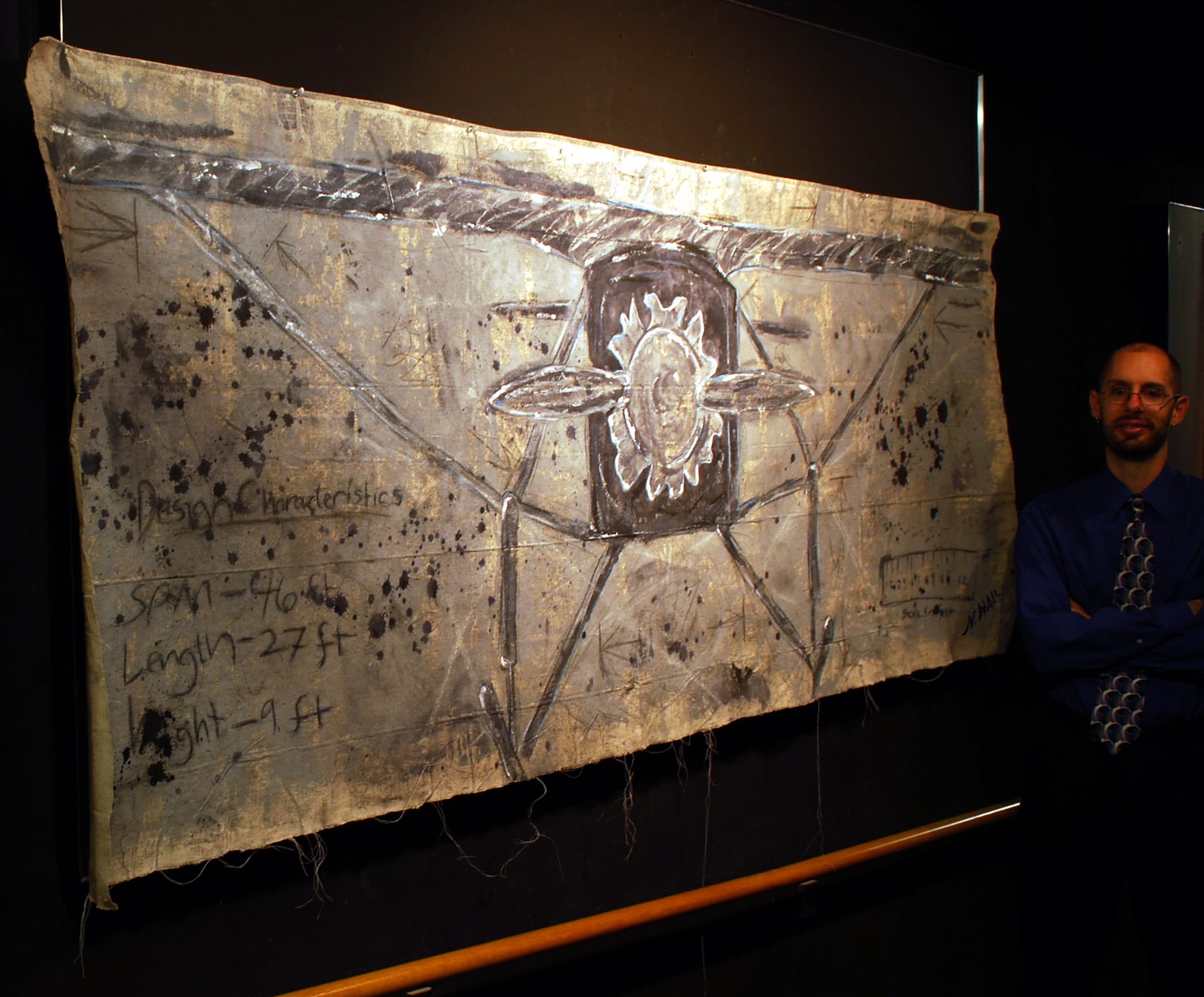 Front View in Silver (The Spirit in Gray) multimedia tapestry by Nova Hall. A massive 39x101 inch unstretched canvas utilizing acrylic, ink, graphite, and latex. The crowning achievement of Nova Hall's mentorship under Leandro Soto. Won First Prize at the ASU West Student Art and Research Show, inspiring the creation of the Flying Over Time 501(c)(3) with Dean Monica Casper. An unparalleled acquisition for aerospace museums and fine art archives.