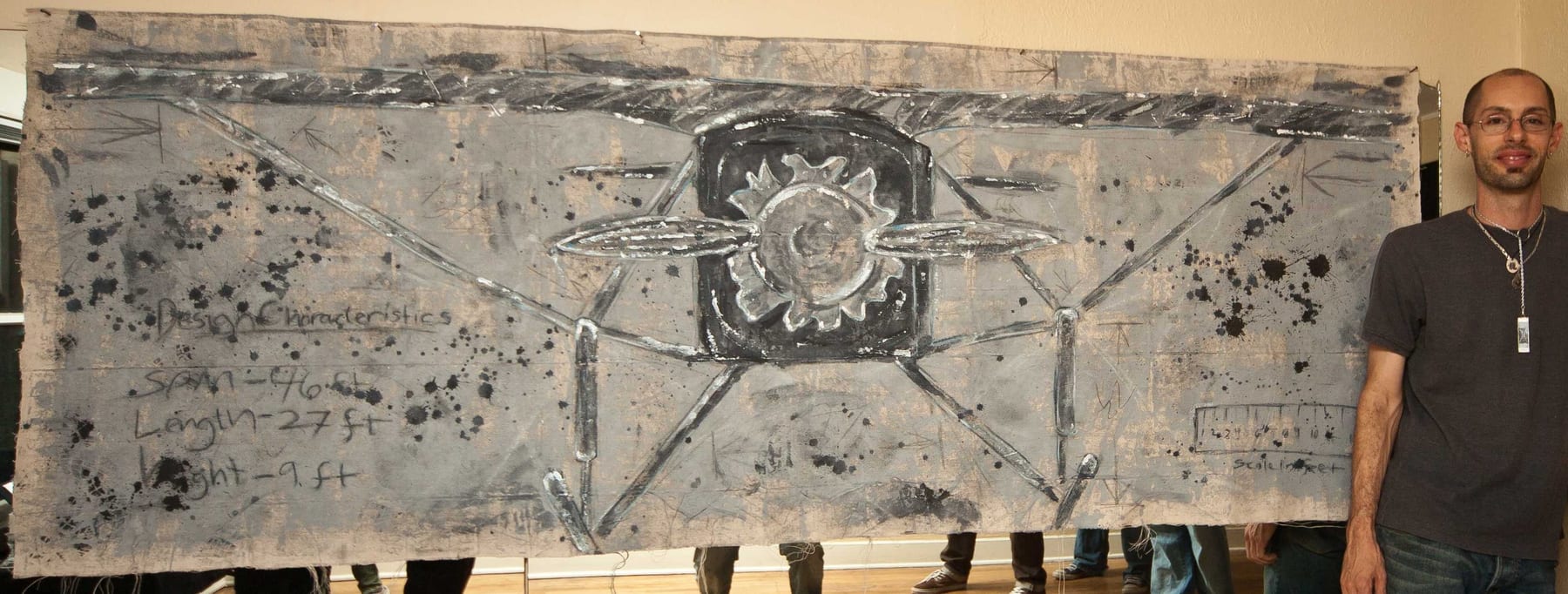 Front View in Silver (The Spirit in Gray) multimedia tapestry by Nova Hall. A massive 39x101 inch unstretched canvas utilizing acrylic, ink, graphite, and latex. The crowning achievement of Nova Hall's mentorship under Leandro Soto. Won First Prize at the ASU West Student Art and Research Show, inspiring the creation of the Flying Over Time 501(c)(3) with Dean Monica Casper. An unparalleled acquisition for aerospace museums and fine art archives.