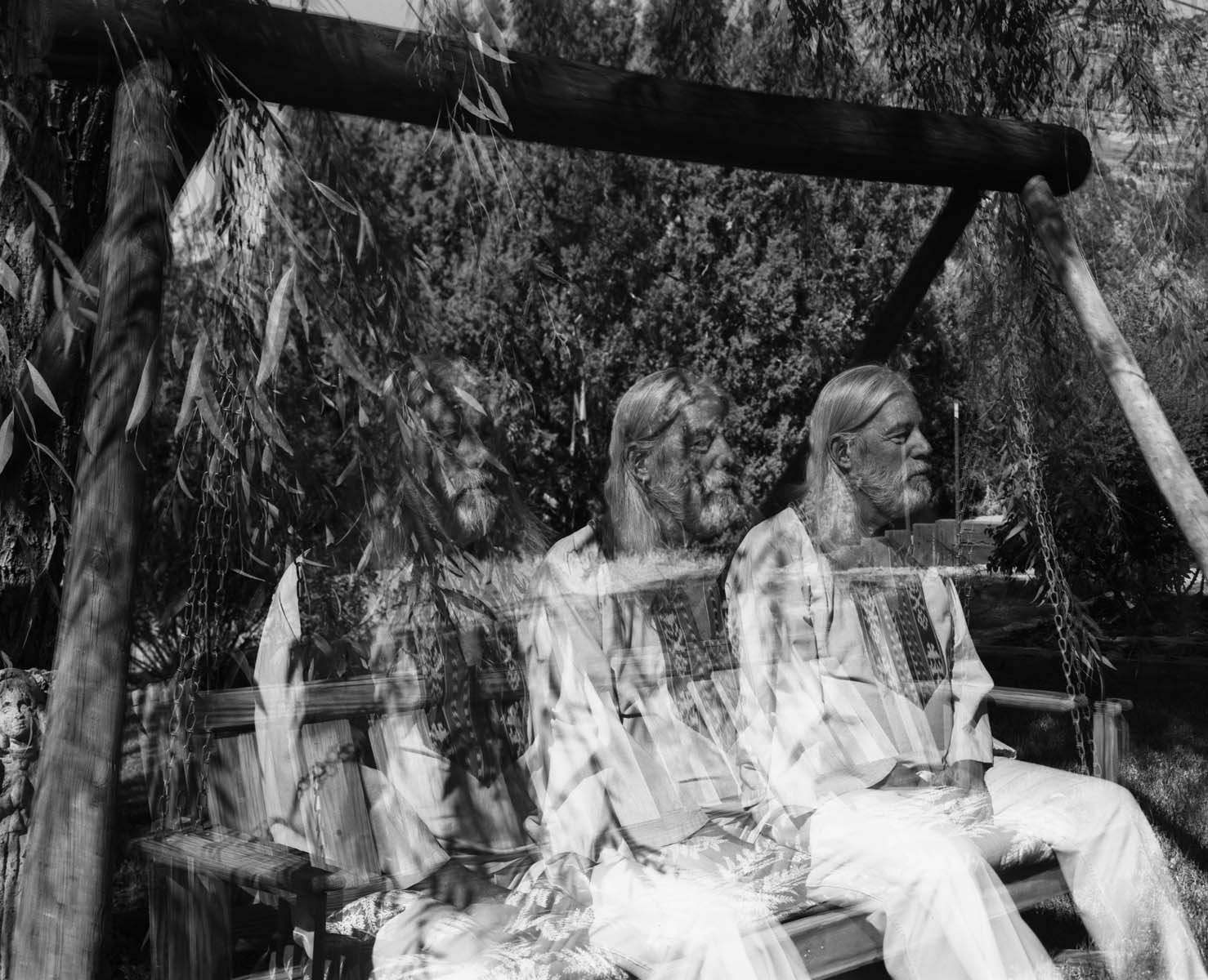 Fine art 4x5 black and white triple exposure photograph of Donald A. Hall Jr. on a garden swing in Sedona by Nova Hall.