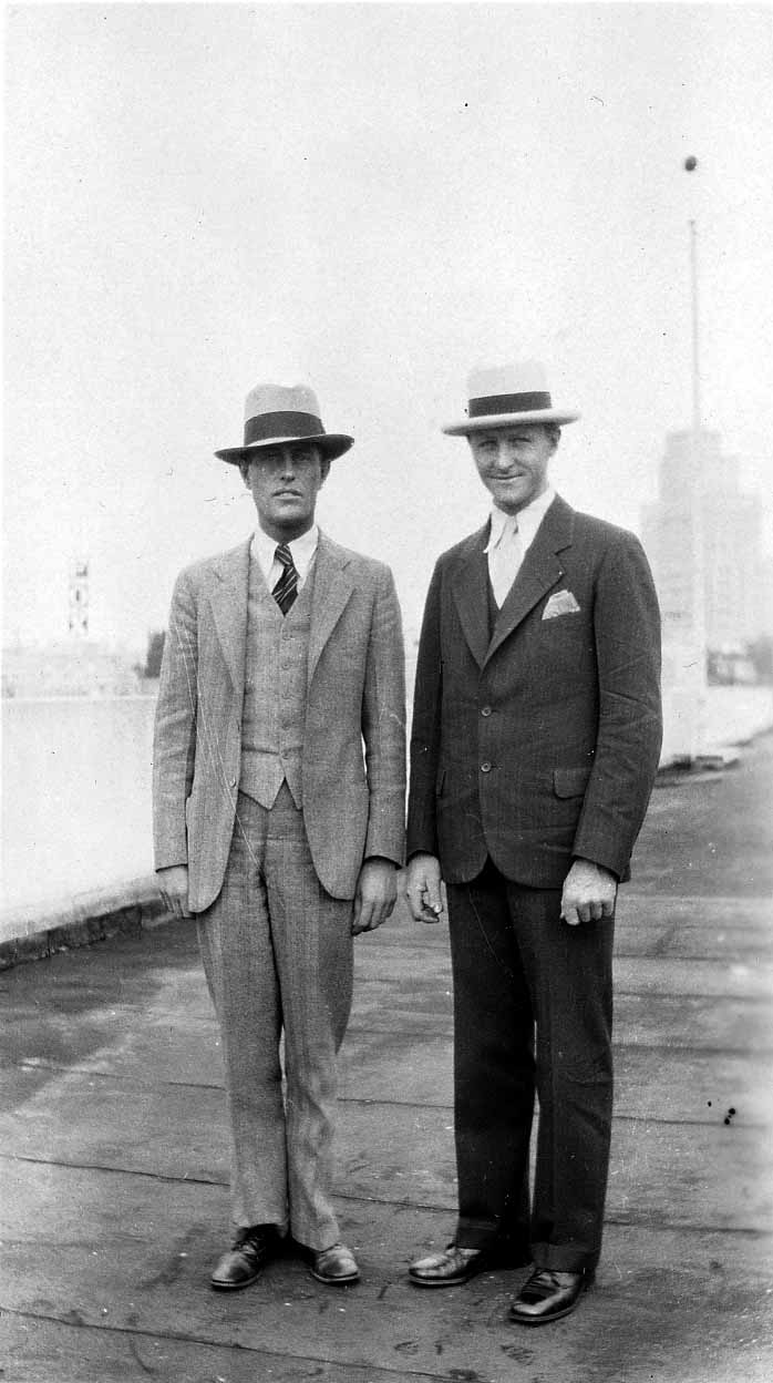 Donald A. Hall Sr. and another man standing on a rooftop, both wearing dapper suits and hats.