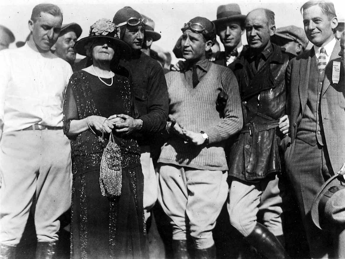Donald Douglas, aviators in flight gear, a flapper-dressed woman, and young Donald A. Hall Sr. at an aviation event.