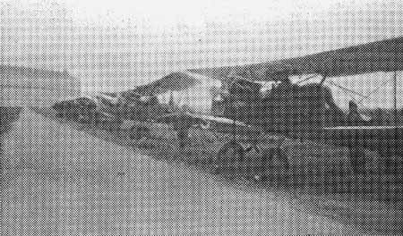 A pixelated halftone print depicting a row of Army Air Corps training biplanes parked on the airfield.