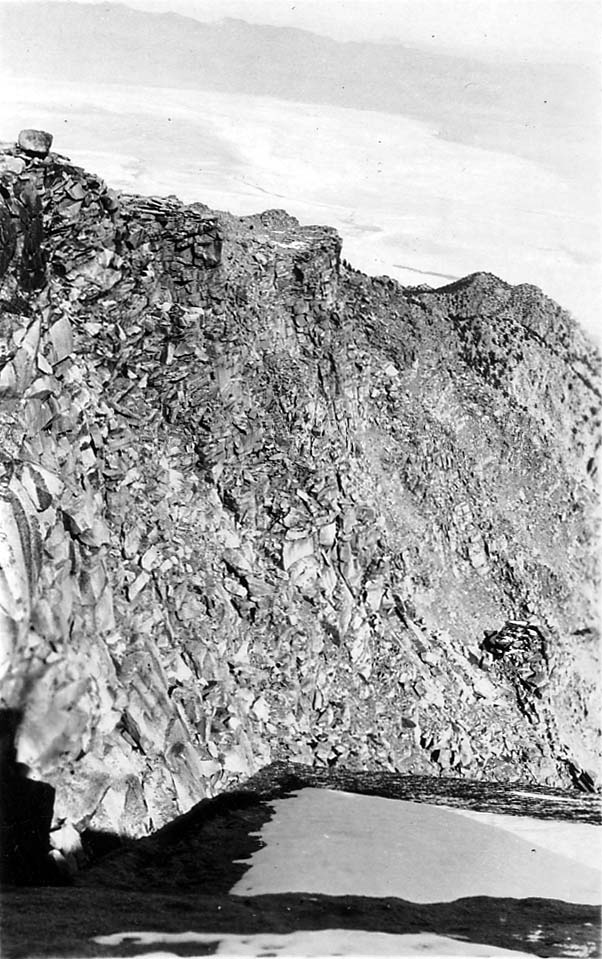 A high-altitude perspective looking down over a vast mountain valley.
