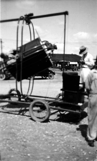 An action shot of the Ruggles Orientator ground simulator pitched sharply backward within its gimbal rings, operated by an instructor.
