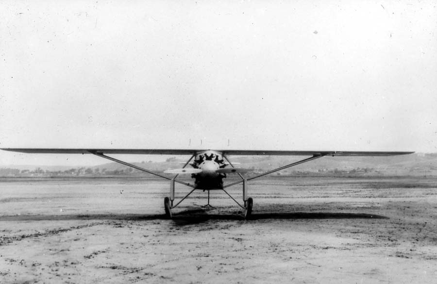 Frontal head-on view of the Spirit of St. Louis on Dutch Flats field with tail elevated on a stand during center-of-gravity testing.