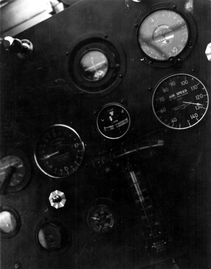 A close-up view of the Spirit of St. Louis instrument panel in mid-flight, showing the altimeter, airspeed indicator, and turn-and-bank indicator.