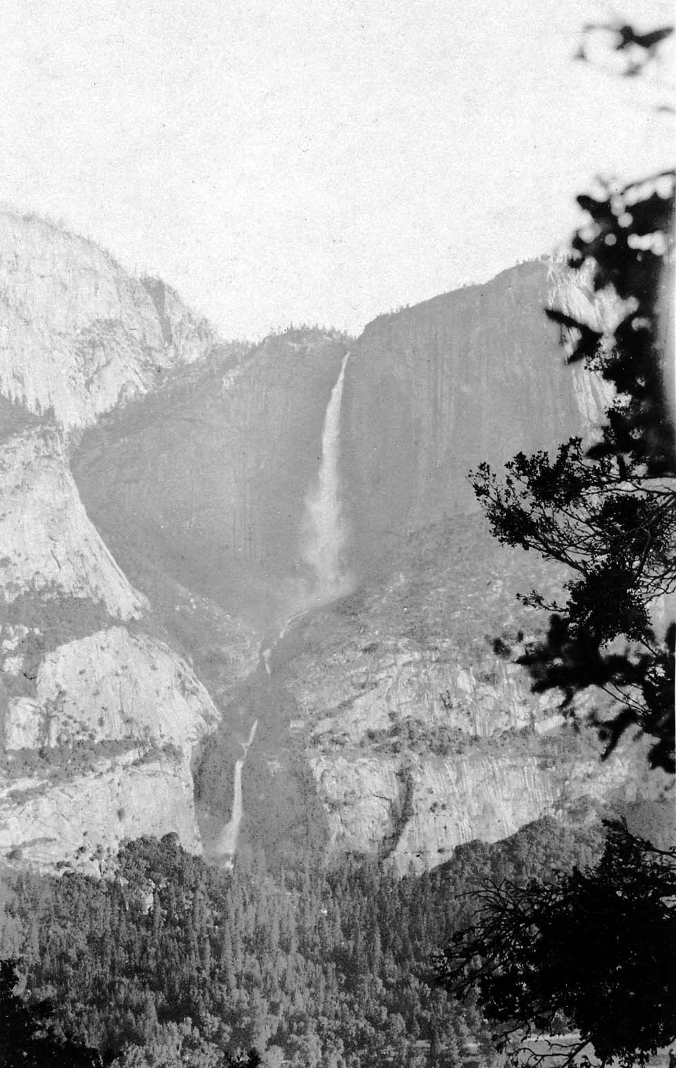 A comprehensive valley-floor perspective capturing both Upper and Lower Yosemite Falls cutting through the towering north valley granite walls.
