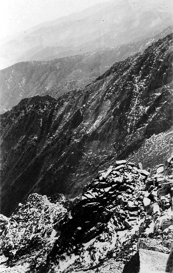 Deep shadows cast across a mountain gorge during the late afternoon.