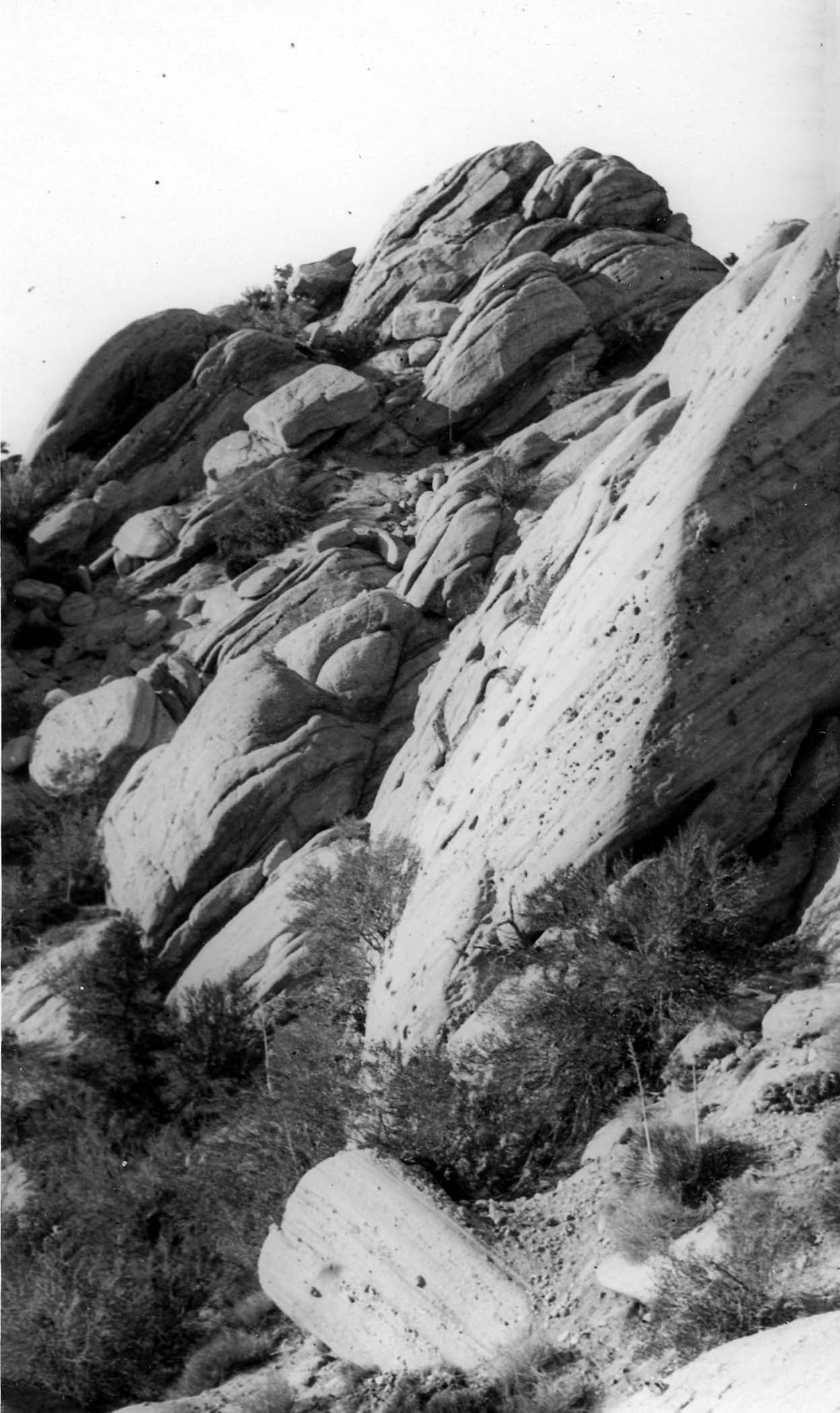 A close-up view of weathered, wind-carved granite boulders and rocky outcroppings on a arid hillside in Southern California.