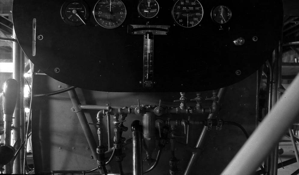 Engineering photograph of the complex fuel manifold, brass selector valves, and copper lines beneath the instrument board.