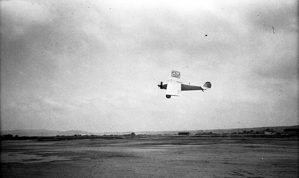 Action photograph of the Spirit of St. Louis in a climbing right bank over Dutch Flats showing underwing registration.