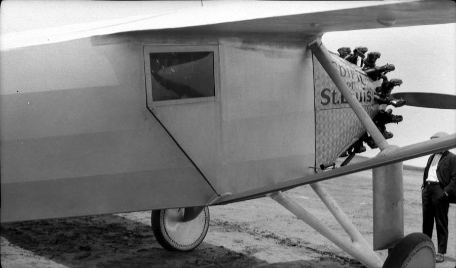Close-up flightline view of the left forward fuselage showing damascened nose cowl, periscope housing, and cockpit door.