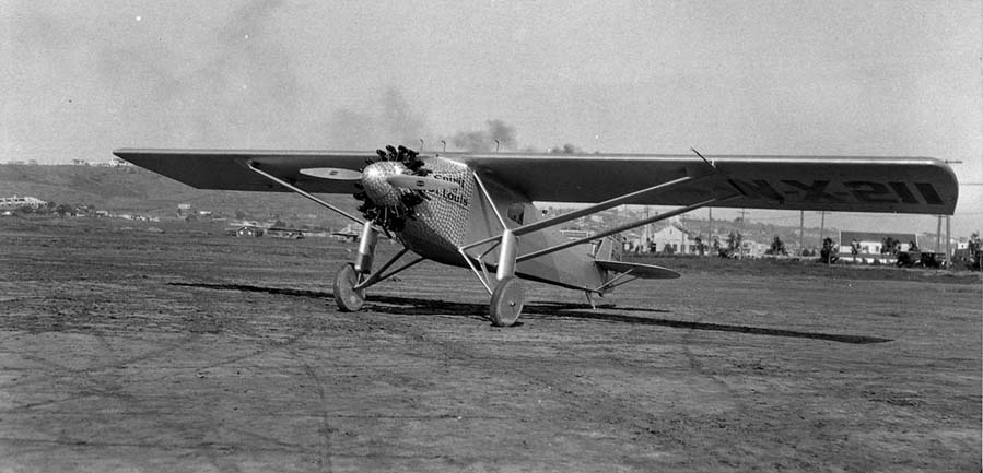 Low-angle front-left three-quarter photograph of the Spirit of St. Louis parked on Dutch Flats dirt apron.