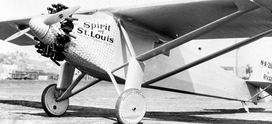 Low-angle three-quarter front-left photograph showing landing gear and Silvertown Airplane Cord fabric wheel cover.
