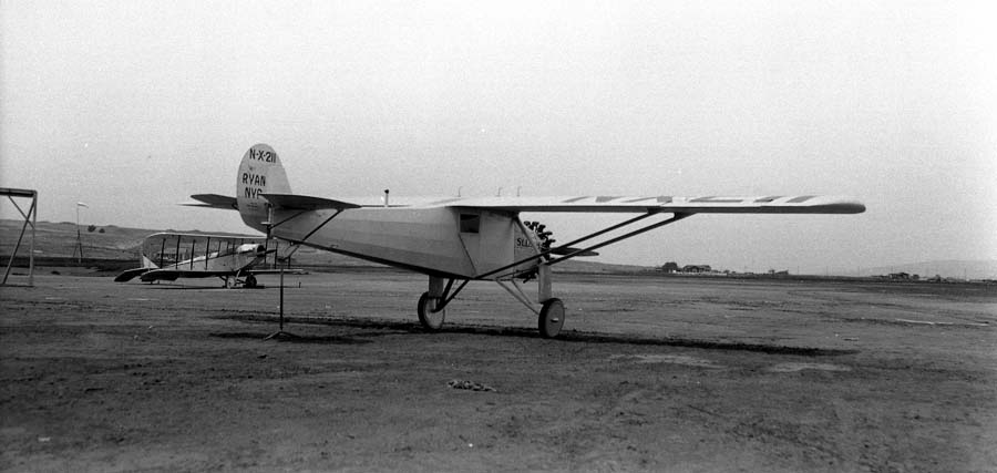 Three-quarter rear view of the Spirit of St. Louis elevated on tail stand showing level cruising flight line.