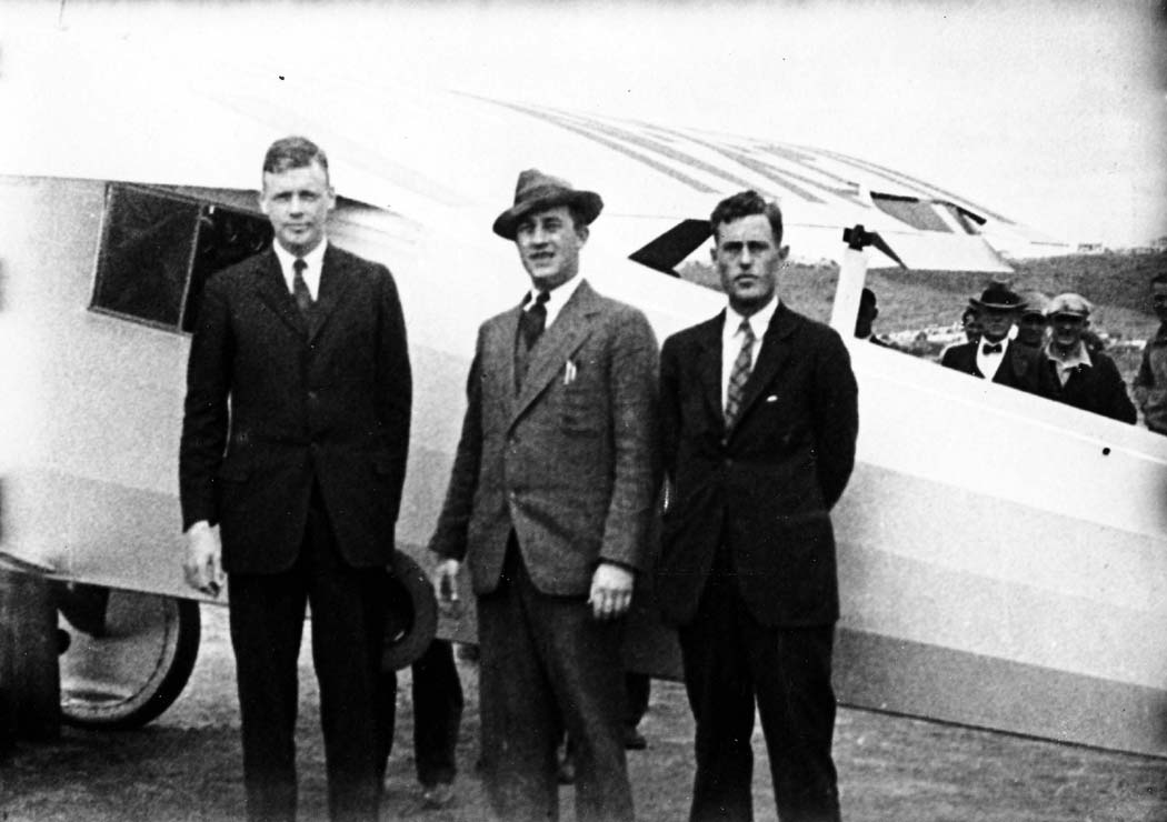 35mm film still of Charles Lindbergh, B.F. Mahoney, and Donald A. Hall standing beside the Spirit of St. Louis.
