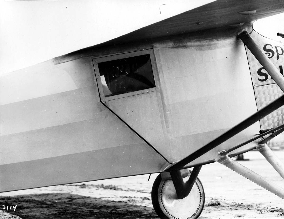 Close-up photograph plate 3114 of the right cockpit door, rectangular window, and landing gear strut fairing.